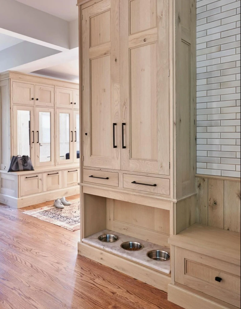 Light Wood Mudroom Cabinetry with Recessed Marble Bowl Niche