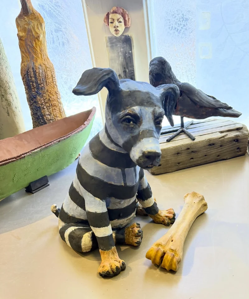 Striped Puppy Figurine with Large Bone on Studio Table