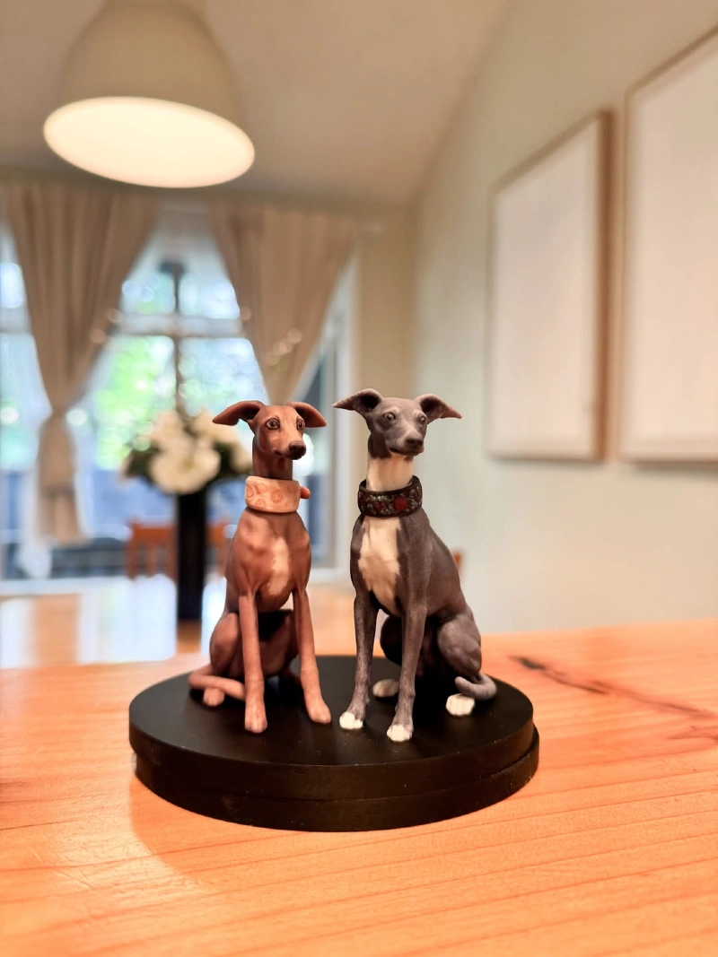 Two Italian Greyhound Figurines on Round Black Base in Bright Room