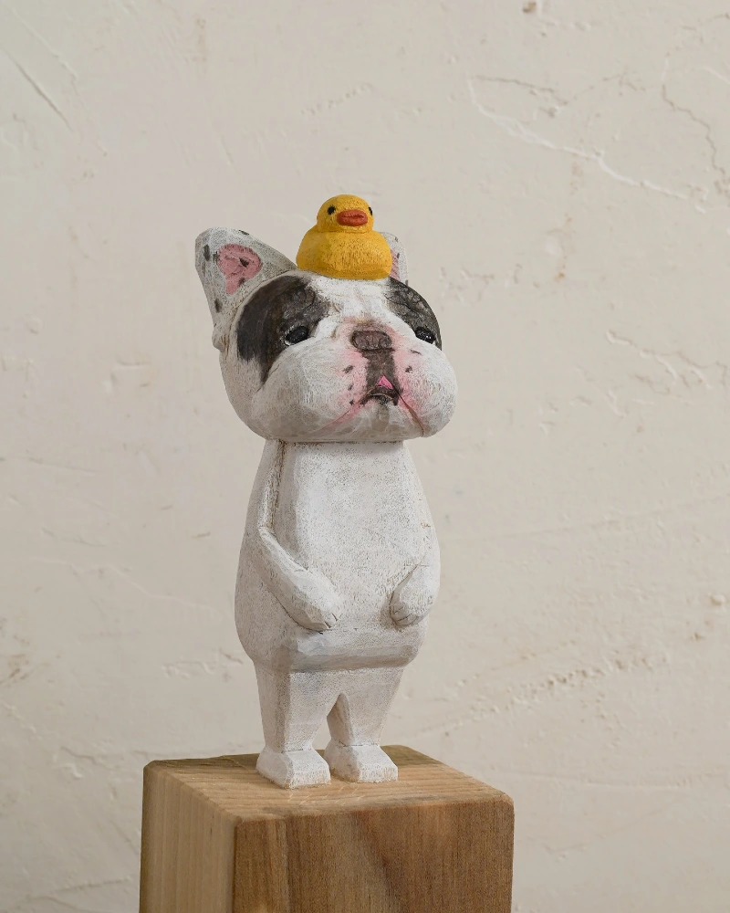 Upright Dog Figurine with Tiny Yellow Duck on Wooden Block