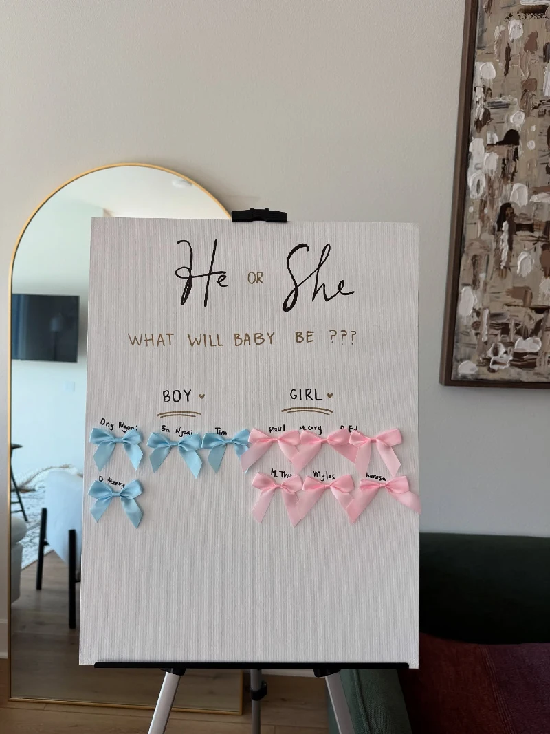 White Guessing Board on an Easel with Blue and Pink Satin Bows